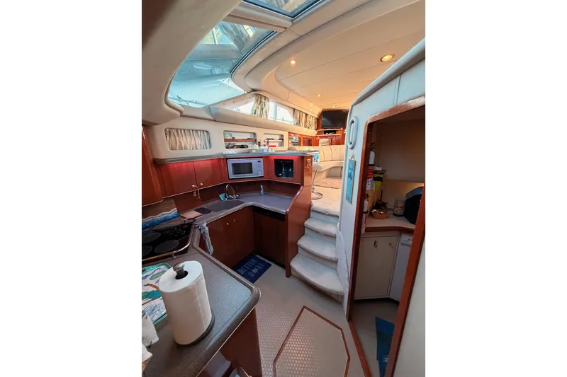 Slide: The Image of Interior of 1998 Sea Ray 420 Aft Cabin yacht with kitchen and seating area. - 70