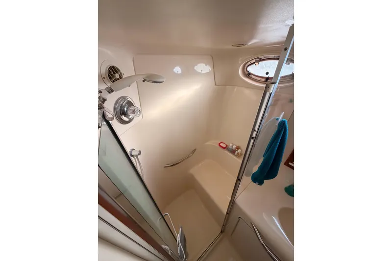 Slide: The Image of Shower area in 1998 Sea Ray 420 Aft Cabin yacht with porthole and towel. - 80