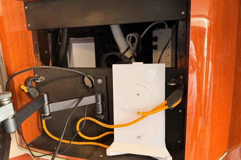 Slide: The Image of 1998 Sea Ray 420 Aft Cabin interior with electronic equipment and wiring setup. - 90