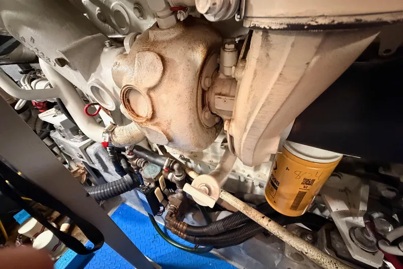 Slide: The Image of Engine components of a 1998 Sea Ray 420 Aft Cabin boat, featuring hoses and filters. - 96