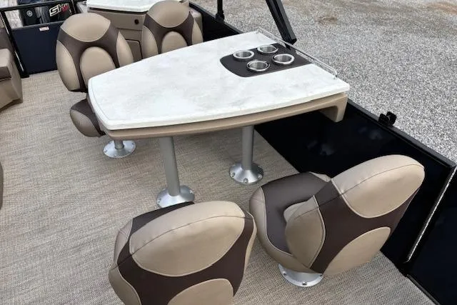 Slide: The Image of 2025 Bennington 23 SXPD boat interior with modern seating and table setup. - 11