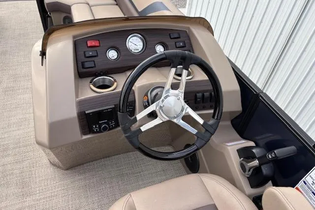 Slide: The Image of 2025 Bennington 23 SXPD boat dashboard with steering wheel and control panel. - 13