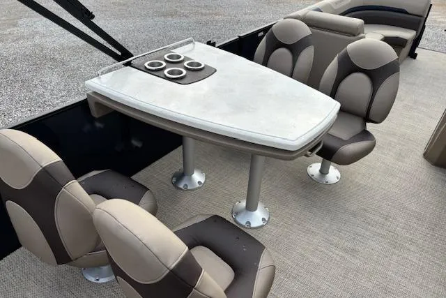 Slide: The Image of 2025 Bennington 23 SXPD boat interior with seating and table setup. - 14