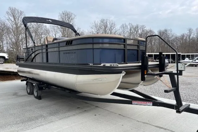 Slide: The Image of 2025 Bennington 23 SXPD pontoon boat on trailer, parked outdoors. - 4