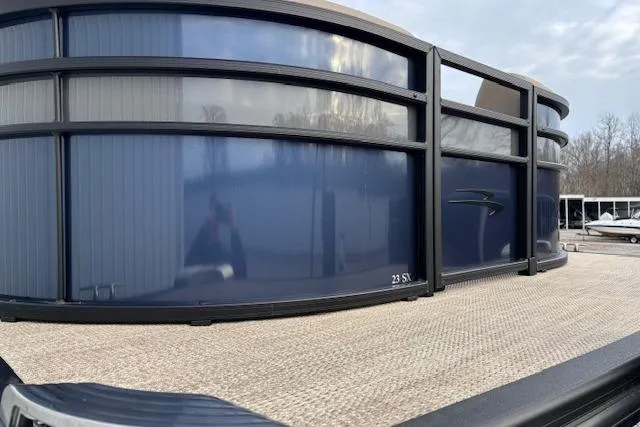 Slide: The Image of 2025 Bennington 23 SXPD pontoon boat with sleek blue exterior design. - 5