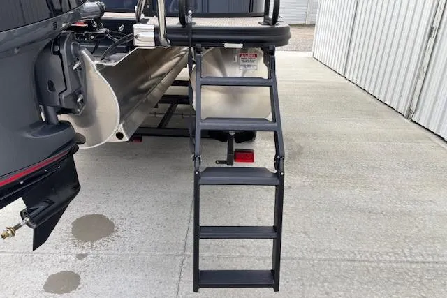 Slide: The Image of 2025 Bennington 23 SXPD boat with rear boarding ladder on concrete surface. - 7
