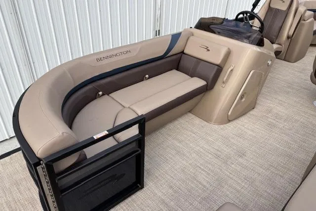 Slide: The Image of 2025 Bennington 23 SXPD pontoon boat interior with beige seating and helm. - 9