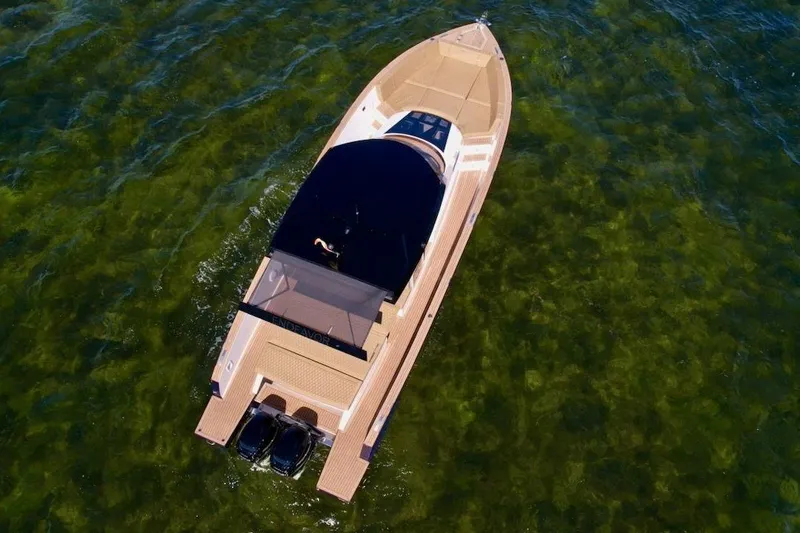 Slide: The Image of Aerial view of 2023 Tesoro T38 boat cruising on clear green water. - 15