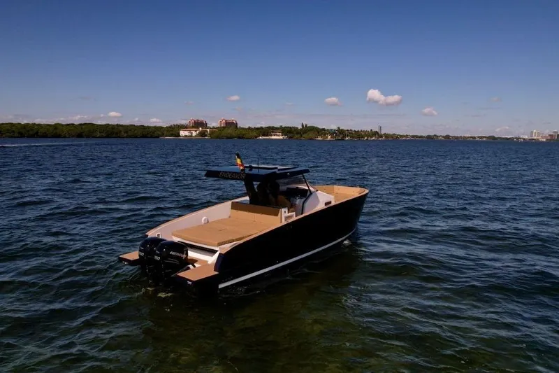 Slide: The Image of 2023 Tesoro T38 boat on calm waters under clear blue sky. - 17
