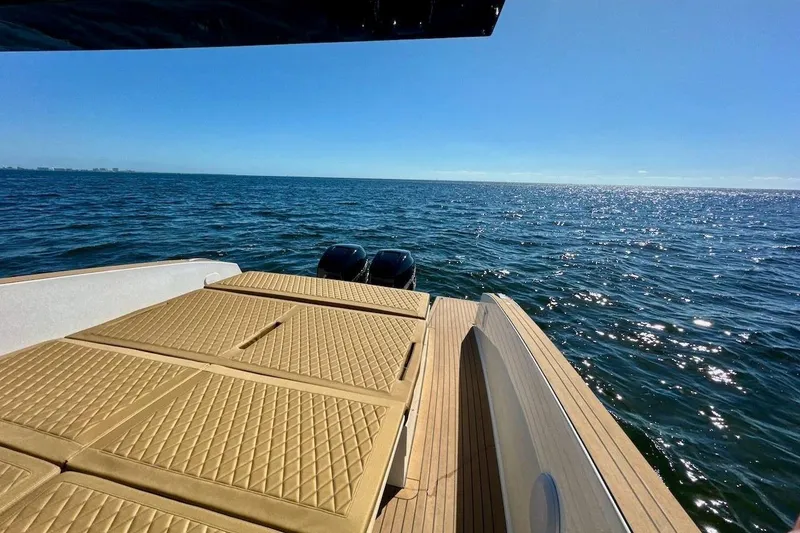 Slide: The Image of 2023 Tesoro T38 yacht with sun deck, overlooking sparkling ocean waters. - 22