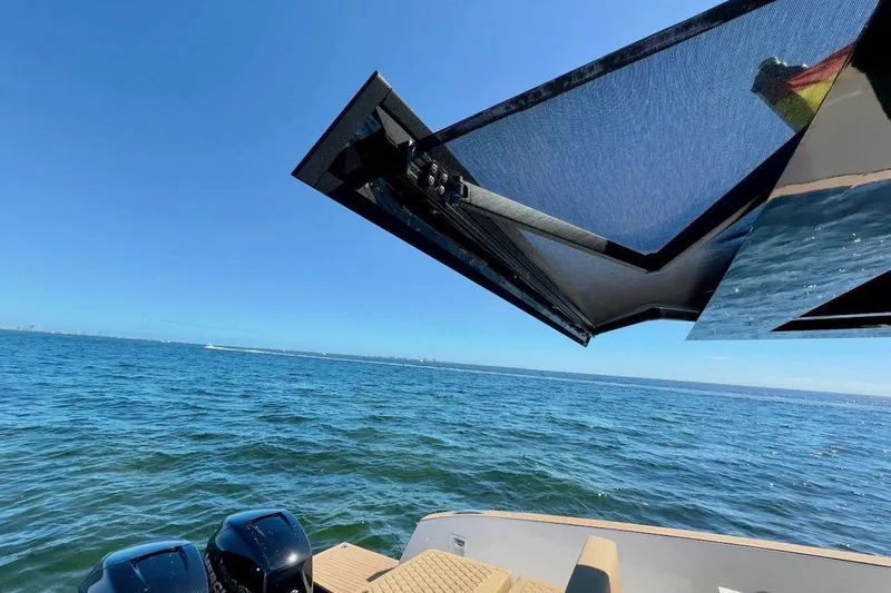 Slide: The Image of 2023 Tesoro T38 boat with sunshade, ocean view, and dual engines. - 28