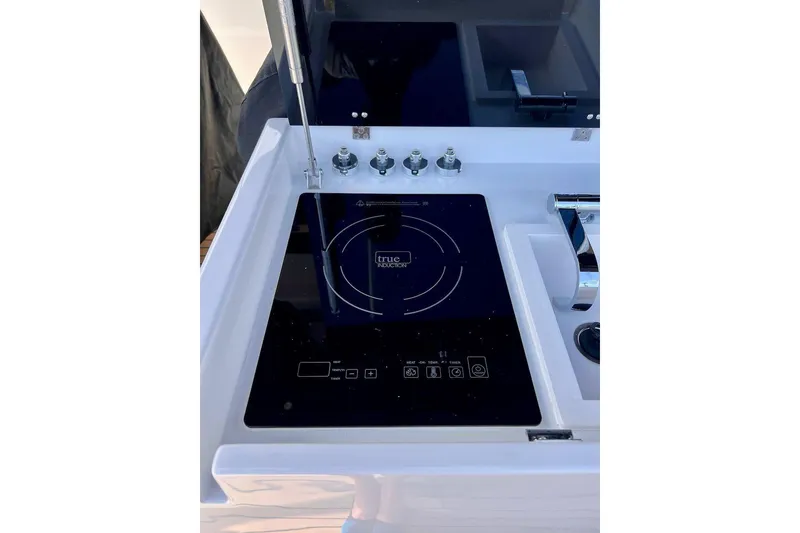 Slide: The Image of 2023 Tesoro T38 yacht kitchen with induction cooktop and modern sink. - 31