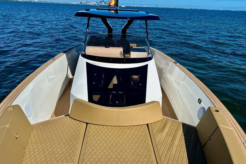 Slide: The Image of 2023 Tesoro T38 luxury boat on open water, featuring sleek design and spacious deck. - 40