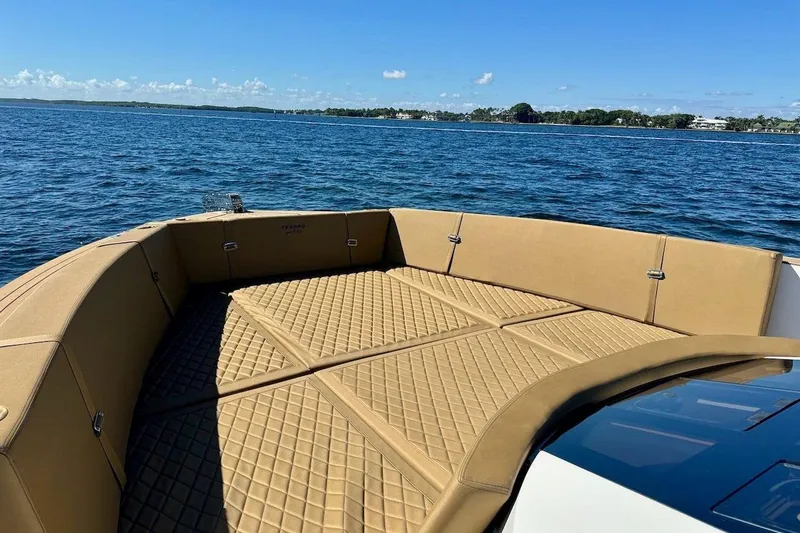 Slide: The Image of Luxurious 2023 Tesoro T38 boat with tan seating on a serene lake. - 41