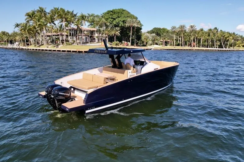 Slide: The Image of 2023 Tesoro T38 boat cruising on a sunny day near a tropical shoreline. - 6