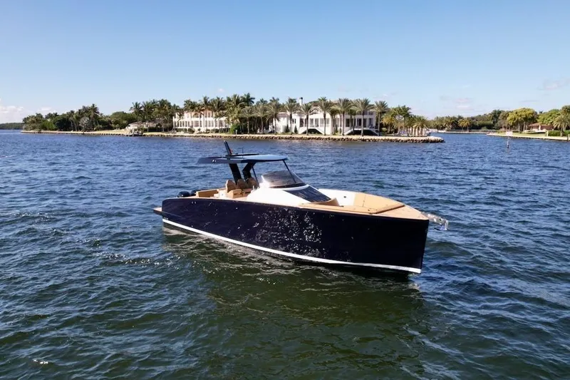 Slide: The Image of 2023 Tesoro T38 yacht cruising on a sunny day near luxury waterfront homes. - 7
