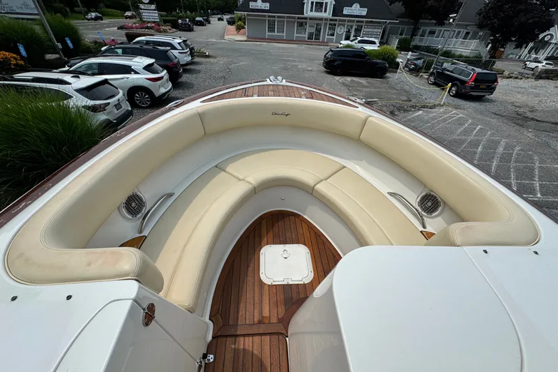 Slide: The Image of 2013 Chris-Craft Launch 28 boat with elegant seating and wooden deck, parked in a lot. - 15