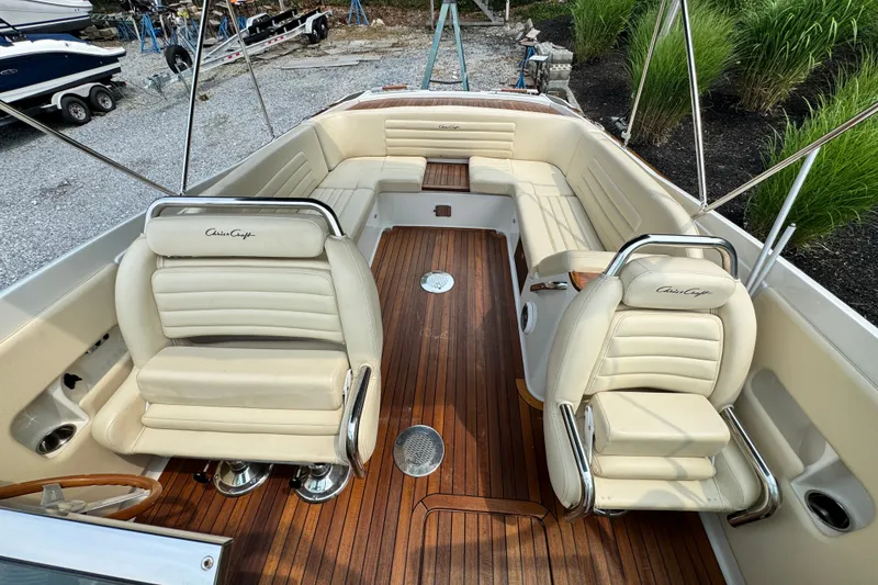Slide: The Image of 2013 Chris-Craft Launch 28 boat interior with cream leather seats and wooden flooring. - 17