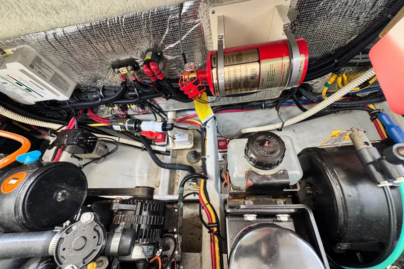Slide: The Image of Engine compartment of a 2013 Chris-Craft Launch 28 with wiring and components visible. - 26