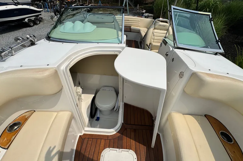 Slide: The Image of 2013 Chris-Craft Launch 28 boat interior with seating and a compact toilet area. - 24