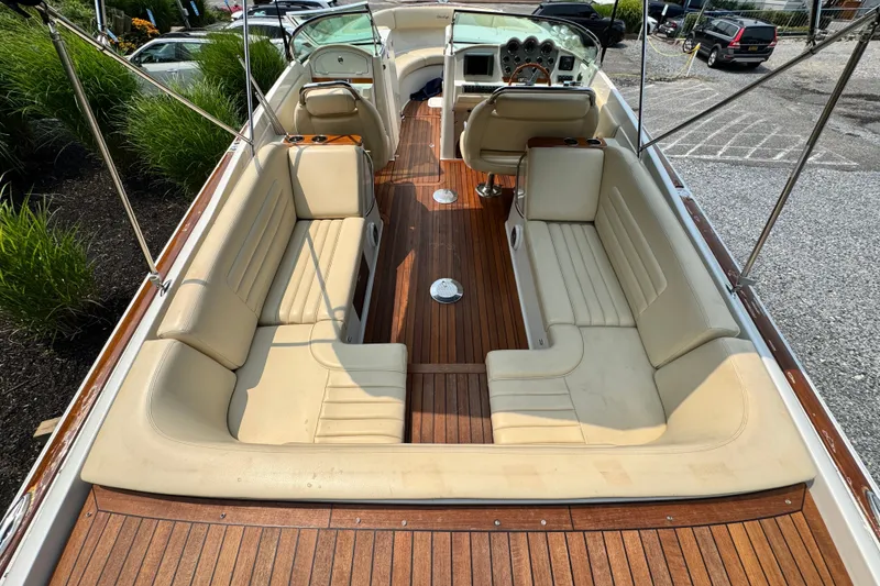 Slide: The Image of 2013 Chris-Craft Launch 28 boat interior with beige seating and wooden flooring. - 9