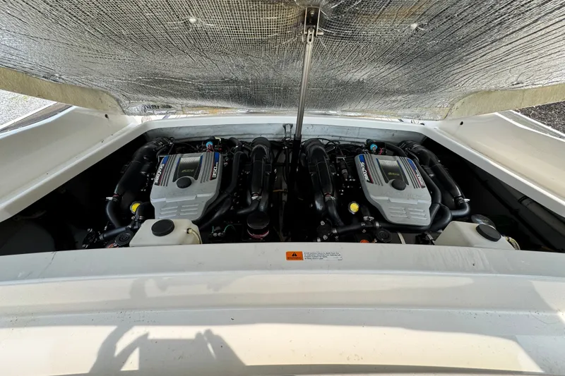 Slide: The Image of Engine compartment of a 2013 Chris-Craft Launch 28 boat, showcasing dual engines. - 25