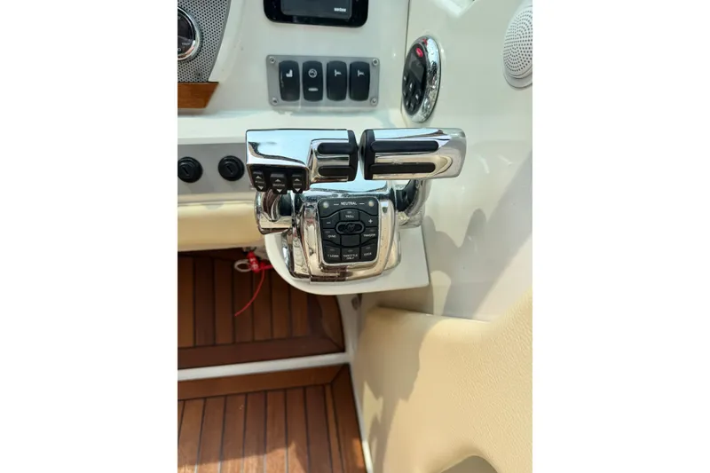 Slide: The Image of Chrome throttle controls on 2013 Chris-Craft Launch 28 boat dashboard. - 13