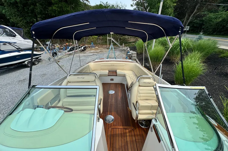Slide: The Image of 2013 Chris-Craft Launch 28 boat with canopy, luxurious seating, and wooden deck. - 16