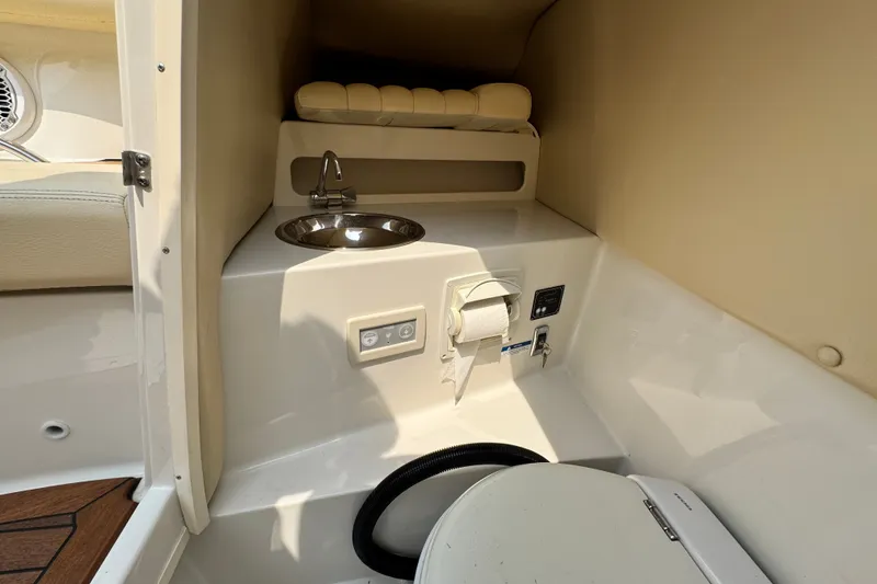 Slide: The Image of 2013 Chris-Craft Launch 28 interior with sink and toilet in compact cabin space. - 23