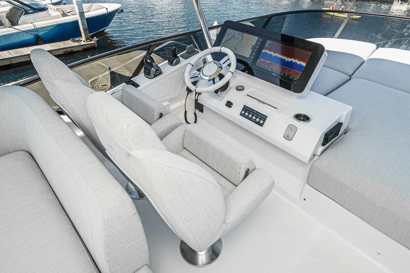 Slide: The Image of 2024 Azimut Fly 53 yacht helm with modern controls and navigation display. - 14