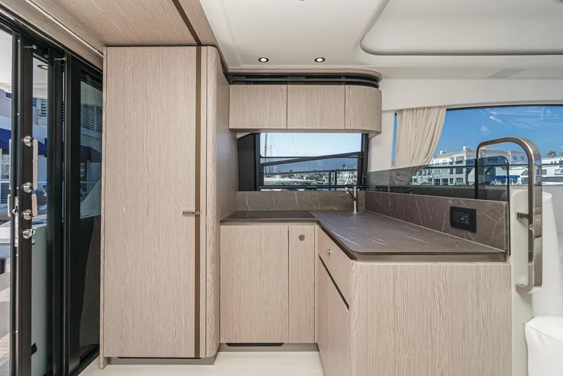 Slide: The Image of Modern kitchen interior of 2024 Azimut Fly 53 yacht with sleek cabinetry and large windows. - 30