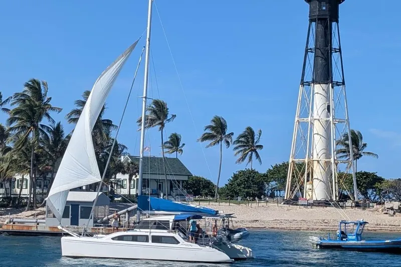 The Image of Sailboat Seawind 1000 XL (2008) near a lighthouse with palm trees in the background. - 0