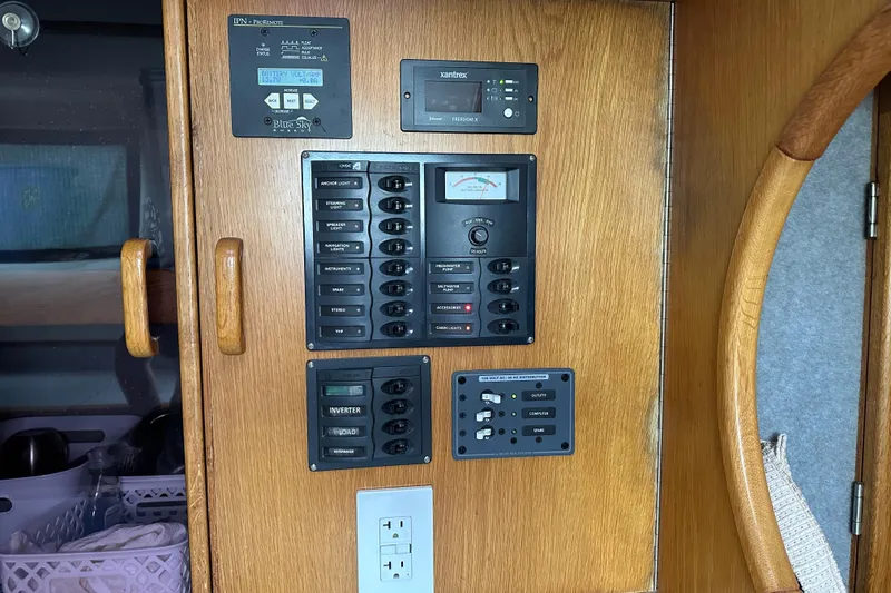 Slide: The Image of Control panel of a 2008 Seawind 1000 XL catamaran, featuring various switches and meters. - 14