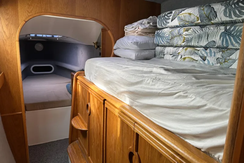Slide: The Image of Interior cabin of a 2008 Seawind 1000 XL catamaran with cozy bedding and wooden cabinetry. - 16