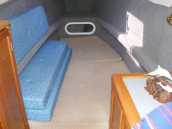 Slide: The Image of Interior of a 2008 Seawind 1000 XL yacht with blue cushions. - 19