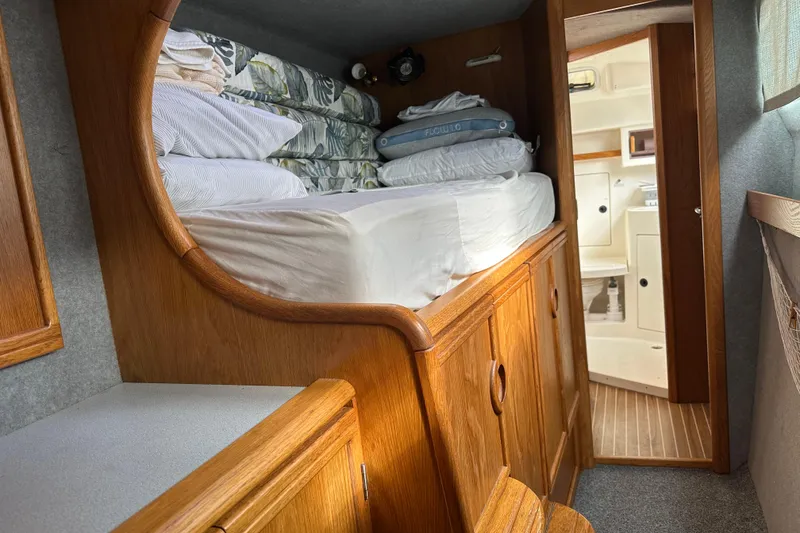 Slide: The Image of Cozy cabin interior of 2008 Seawind 1000 XL catamaran with wooden furnishings and bedding. - 22