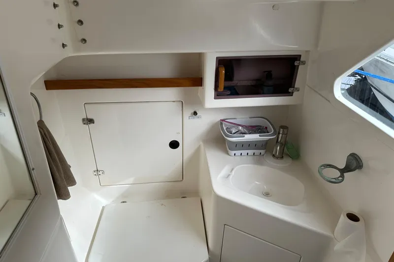 Slide: The Image of 2008 Seawind 1000 XL boat interior with sink, storage, and window. - 23