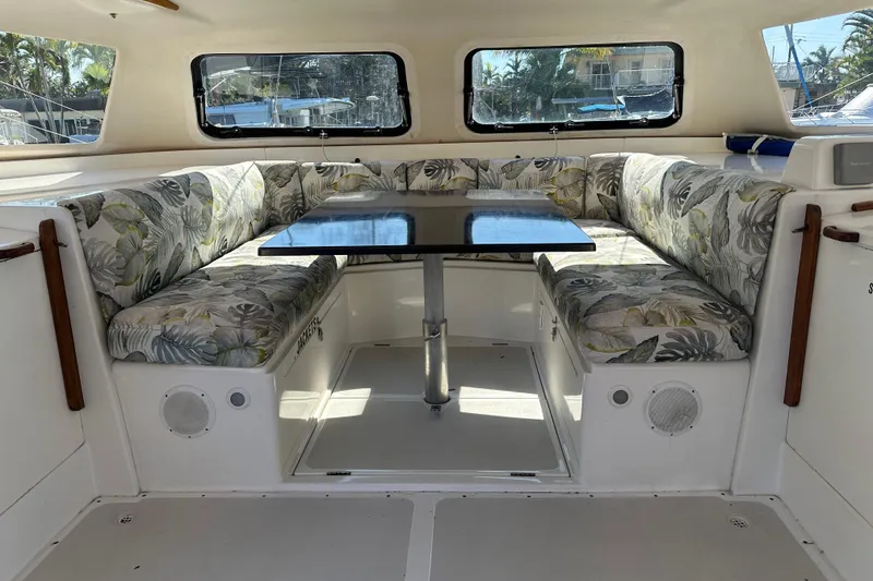 Slide: The Image of Interior of 2008 Seawind 1000 XL catamaran with tropical-patterned seating and central table. - 43