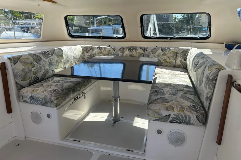 Slide: The Image of Interior of 2008 Seawind 1000 XL catamaran with floral-patterned seating and a central table. - 44