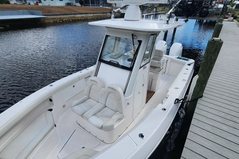Slide: The Image of 2017 Everglades 255 Center Console boat docked by a wooden pier. - 11