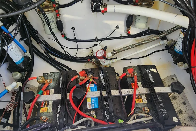 Slide: The Image of Battery compartment of a 2017 Everglades 255 Center Console boat, showing wiring and components. - 28