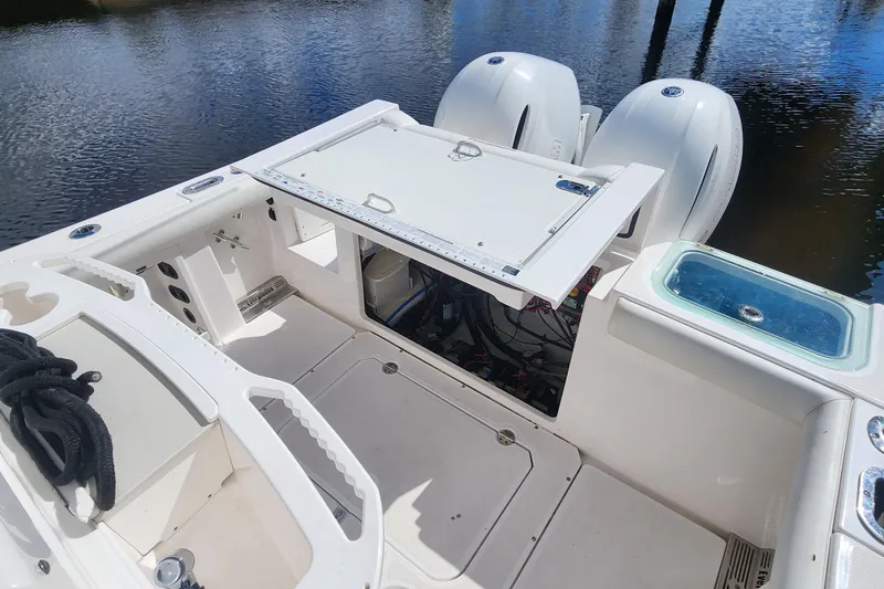 Slide: The Image of 2017 Everglades 255 Center Console boat interior with open hatch and twin engines. - 29