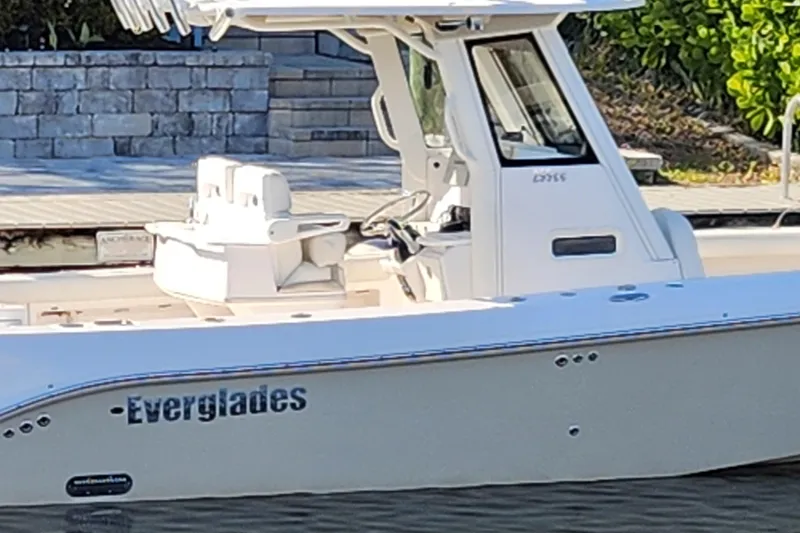 Slide: The Image of 2017 Everglades 255 Center Console boat docked near stone wall. - 3