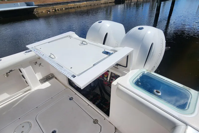 Slide: The Image of 2017 Everglades 255 Center Console boat with open hatch and twin Yamaha engines. - 30