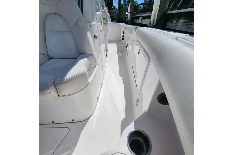 Slide: The Image of 2017 Everglades 255 Center Console boat interior with white seating and storage compartments. - 36