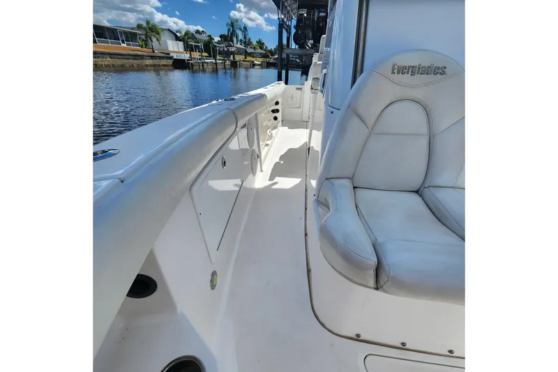 Slide: The Image of 2017 Everglades 255 Center Console boat interior with white seating and canal view. - 37