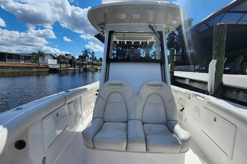 Slide: The Image of 2017 Everglades 255 Center Console boat docked by a scenic waterfront. - 38