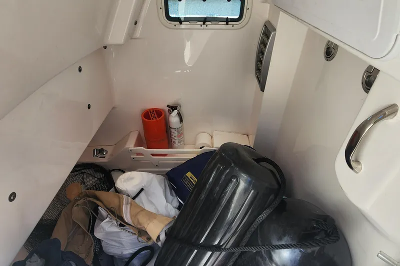 Slide: The Image of Interior of 2017 Everglades 255 Center Console with safety equipment and storage items. - 39
