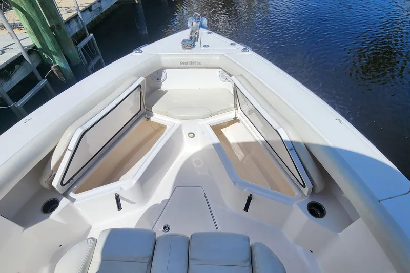 Slide: The Image of 2017 Everglades 255 Center Console boat with open storage compartments on calm water. - 42