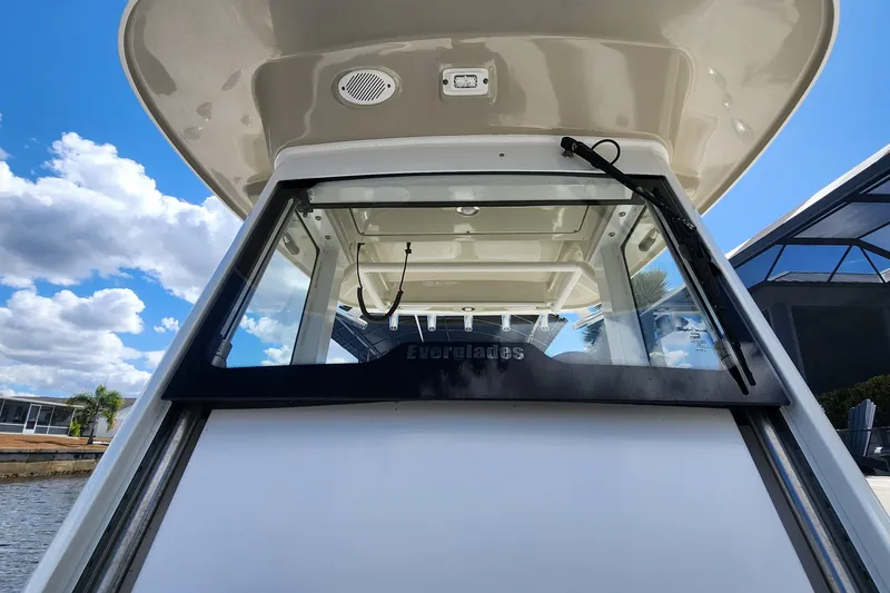 Slide: The Image of 2017 Everglades 255 Center Console boat with windshield, under a blue sky. - 47